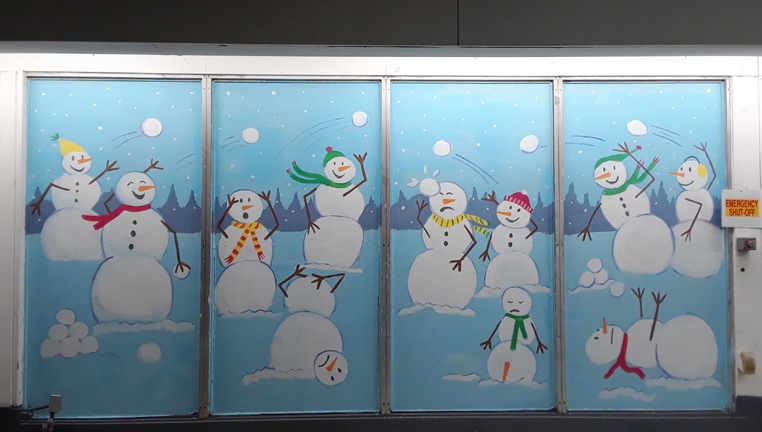 Whimsical snowman mural on a window in Sterling, VA
