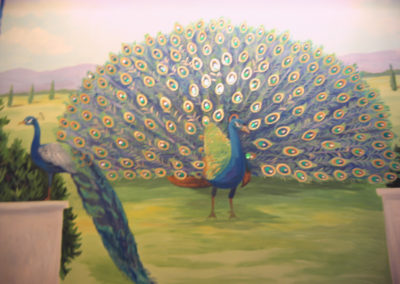 in progress peacock mural with gold and jewels in Fairfax VA
