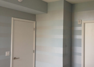 Horizontal painted stripes in blue and silver for bedroom